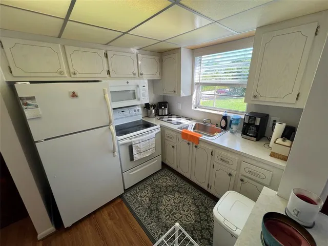 a kitchen with a white cabinets and white appliances