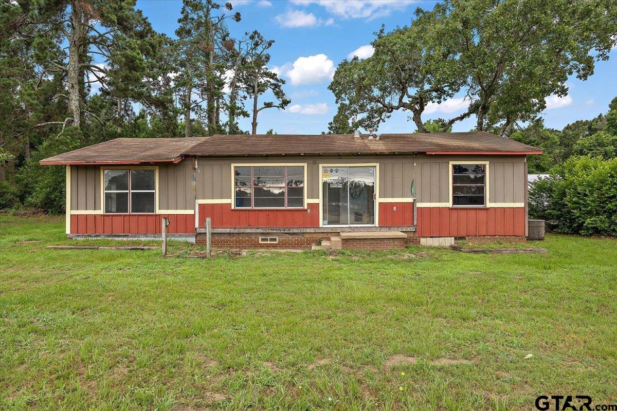 1535 North Dickinson Drive Rusk, TX 75785 - Photo 10 of 18 a view of a house with a backyard and a tree