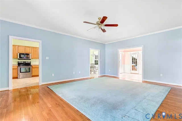 a view of a livingroom with a window and wooden floor