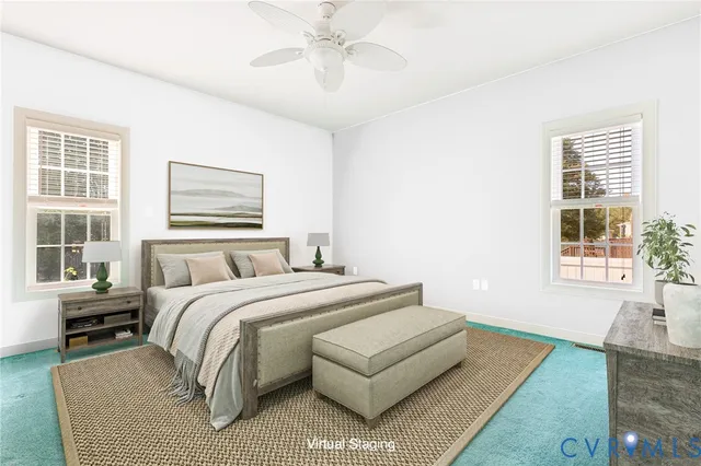 a living room with a bed furniture and next to a window