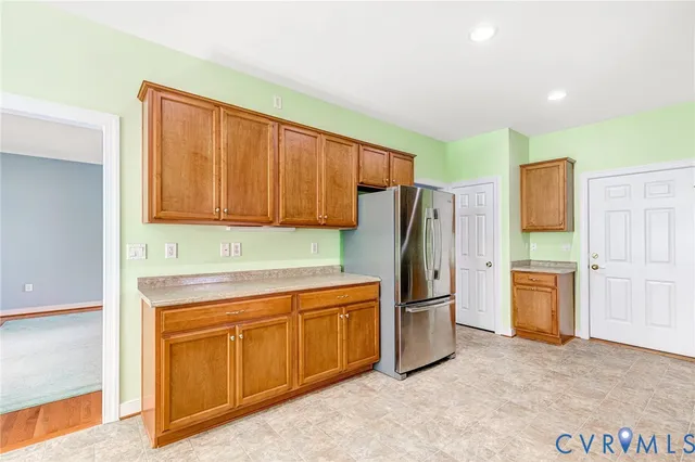 a kitchen with stainless steel appliances granite countertop a refrigerator and a stove top oven