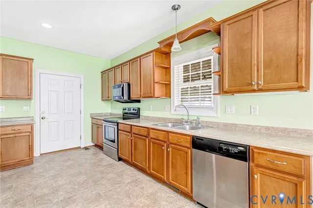 a kitchen with stainless steel appliances granite countertop a sink and a stove