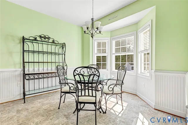 a view of a room that has a window and furniture