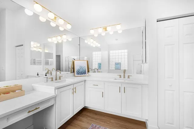 a bathroom with a sink vanity granite and a mirror