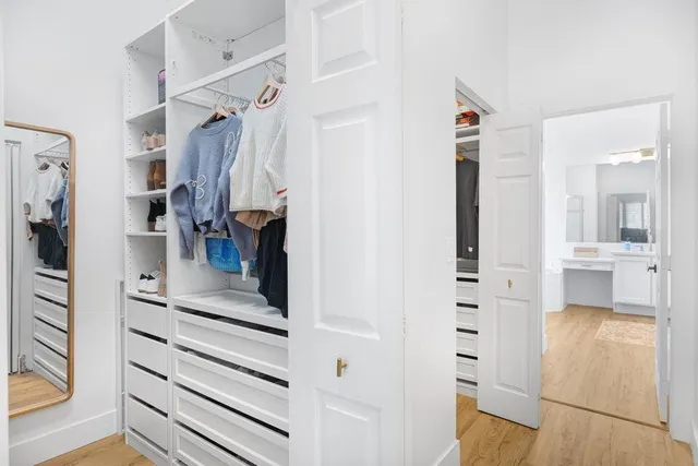 a view of walk in closet with living room