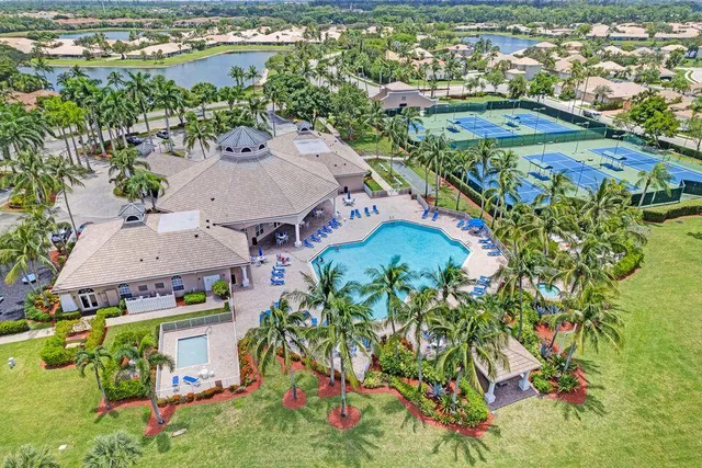 an aerial view of residential houses with outdoor space and swimming pool