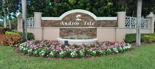 a sign that is in front of flowers