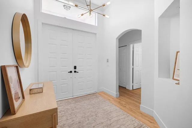 a view of a livingroom with wooden floor and a ceiling fan