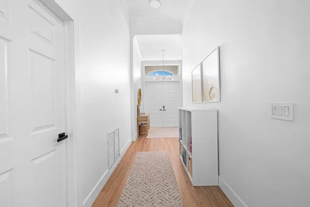 a view of a hallway with wooden floor