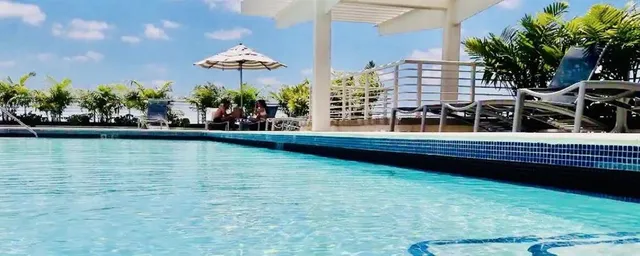 a view of a swimming pool and an outdoor seating