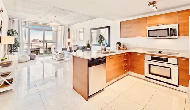 a kitchen with a sink stove and cabinets