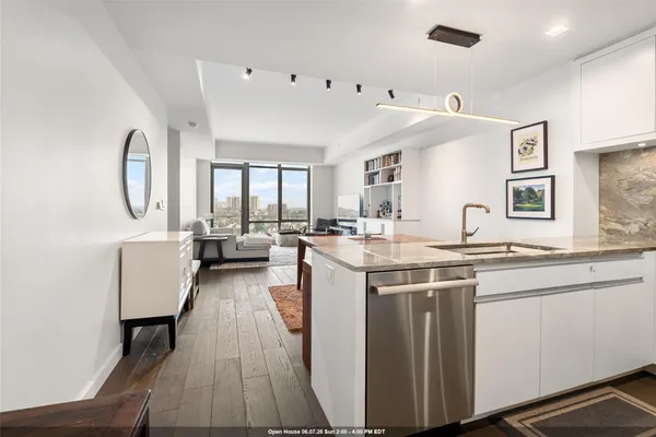 a kitchen with stainless steel appliances granite countertop a sink a stove and a refrigerator