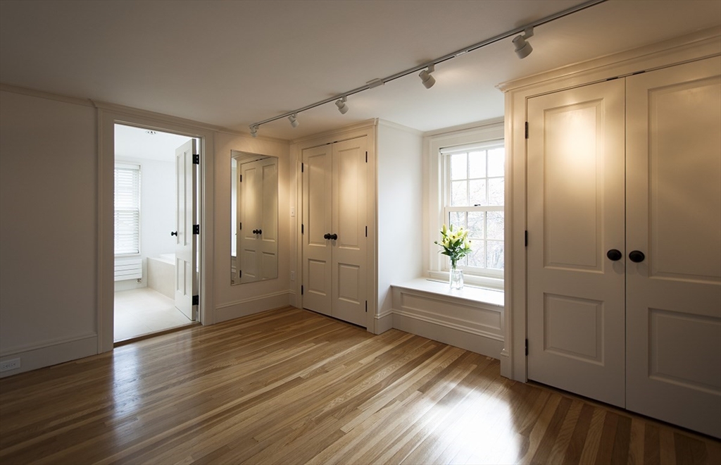 153 Watson Road Belmont, MA 02478 - Photo 9 of 20 a view of a hallway with wooden floor and closet area