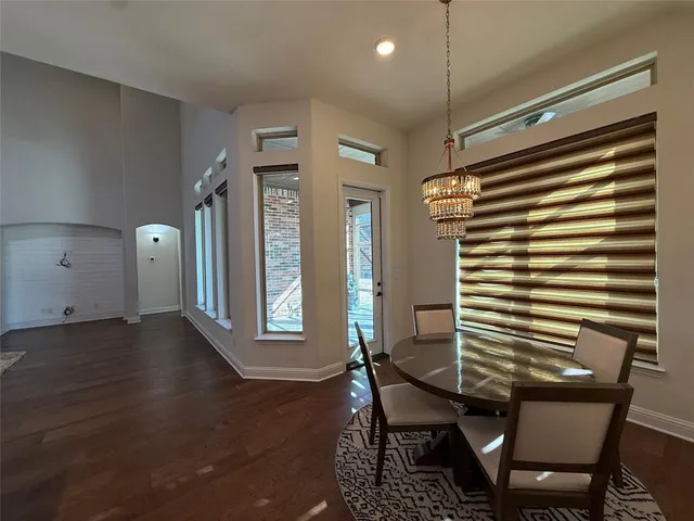 a view of a room with furniture and wooden floor