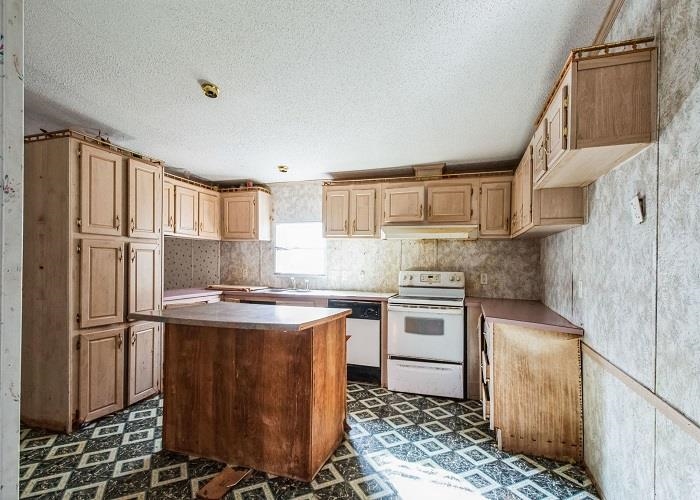 4414 Covey Hollow Road Culleoka, TN 38451 - Photo 6 of 16 a kitchen with stainless steel appliances granite countertop a stove a sink and a refrigerator