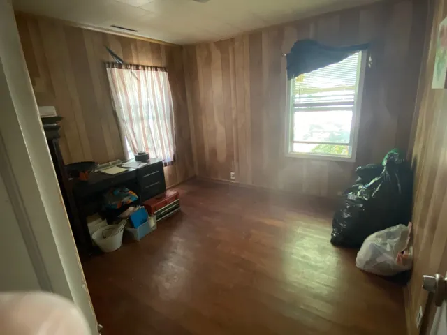 a room with wooden floor and a window