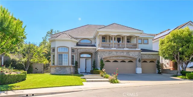 a front view of a house with a garden and plants