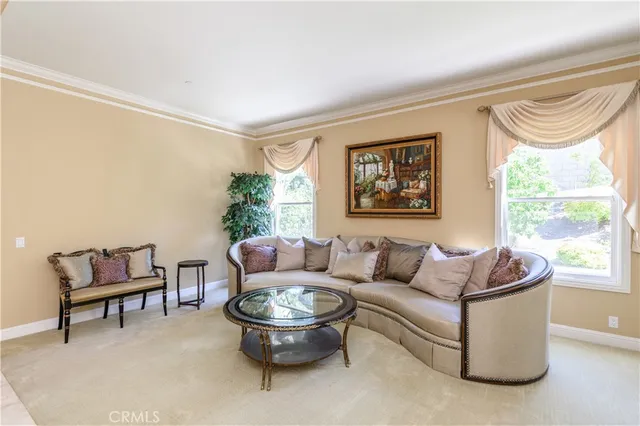 a dining room with furniture a chandelier and wooden floor