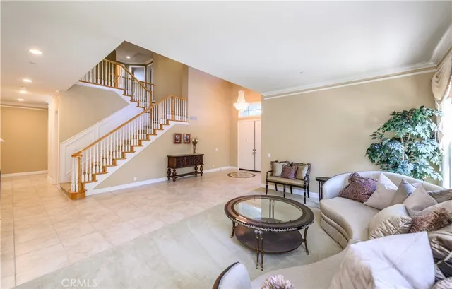 a kitchen with stainless steel appliances granite countertop a sink a counter top space and living room view