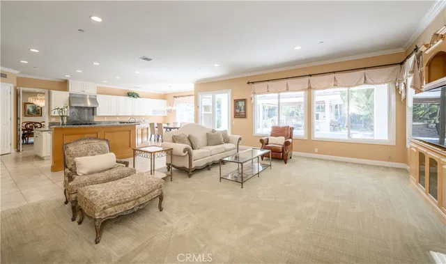 a large open kitchen with a large window and stainless steel appliances