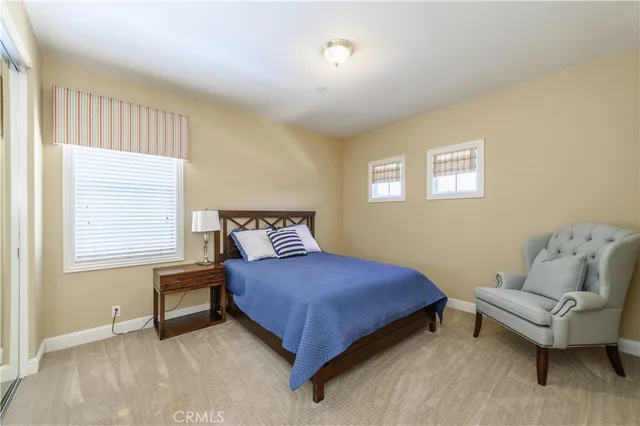 a spacious bedroom with a bed and glass window