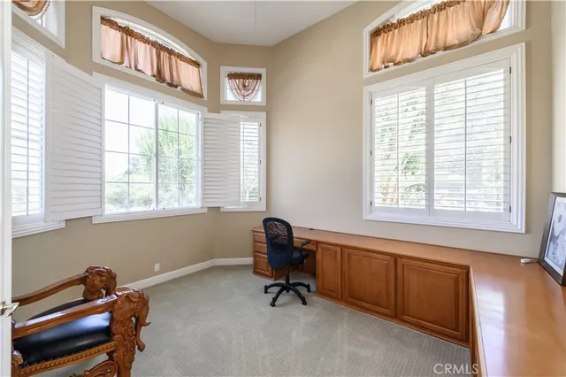 a living room with furniture and a chair