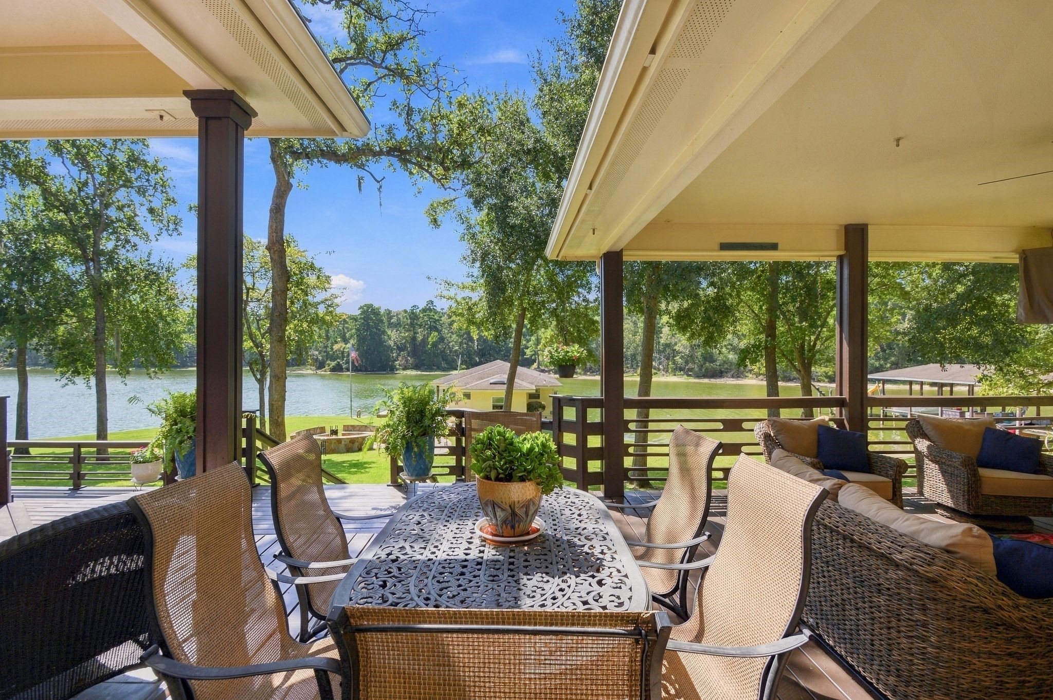 20341 Bay Hill Road Point Blank, TX 77364 - Photo 32 of 50 Outdoor deck with elegant seating, offering serene lake views and surrounded by lush greenery, perfect for entertaining or relaxing.