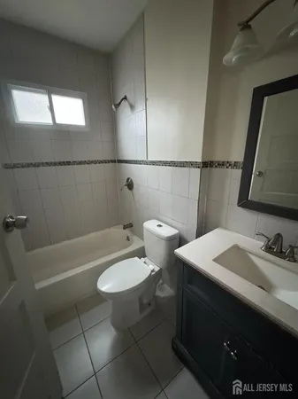a bathroom with a sink toilet and mirror