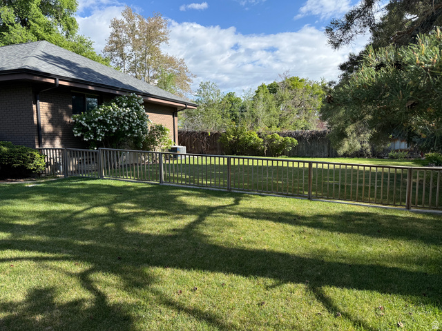 362 East 9150th Street South Sandy, UT 84070 - Photo 38 of 41 Expansive green lawn framed by a wooden fence