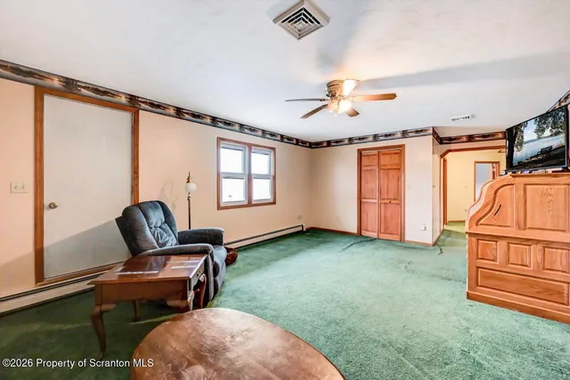 a kitchen with stainless steel appliances granite countertop a refrigerator a sink dishwasher a dining table and chairs with wooden floor