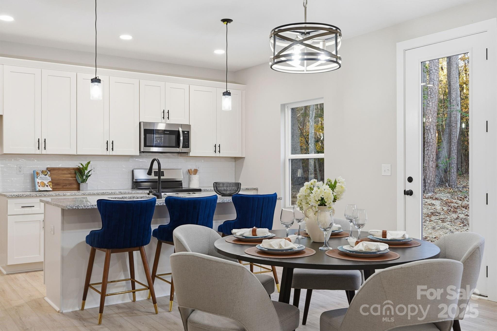 285 Mainsail Road Salisbury, NC 28146 - Photo 12 of 41 a view of a dining room with furniture a chandelier and wooden floor