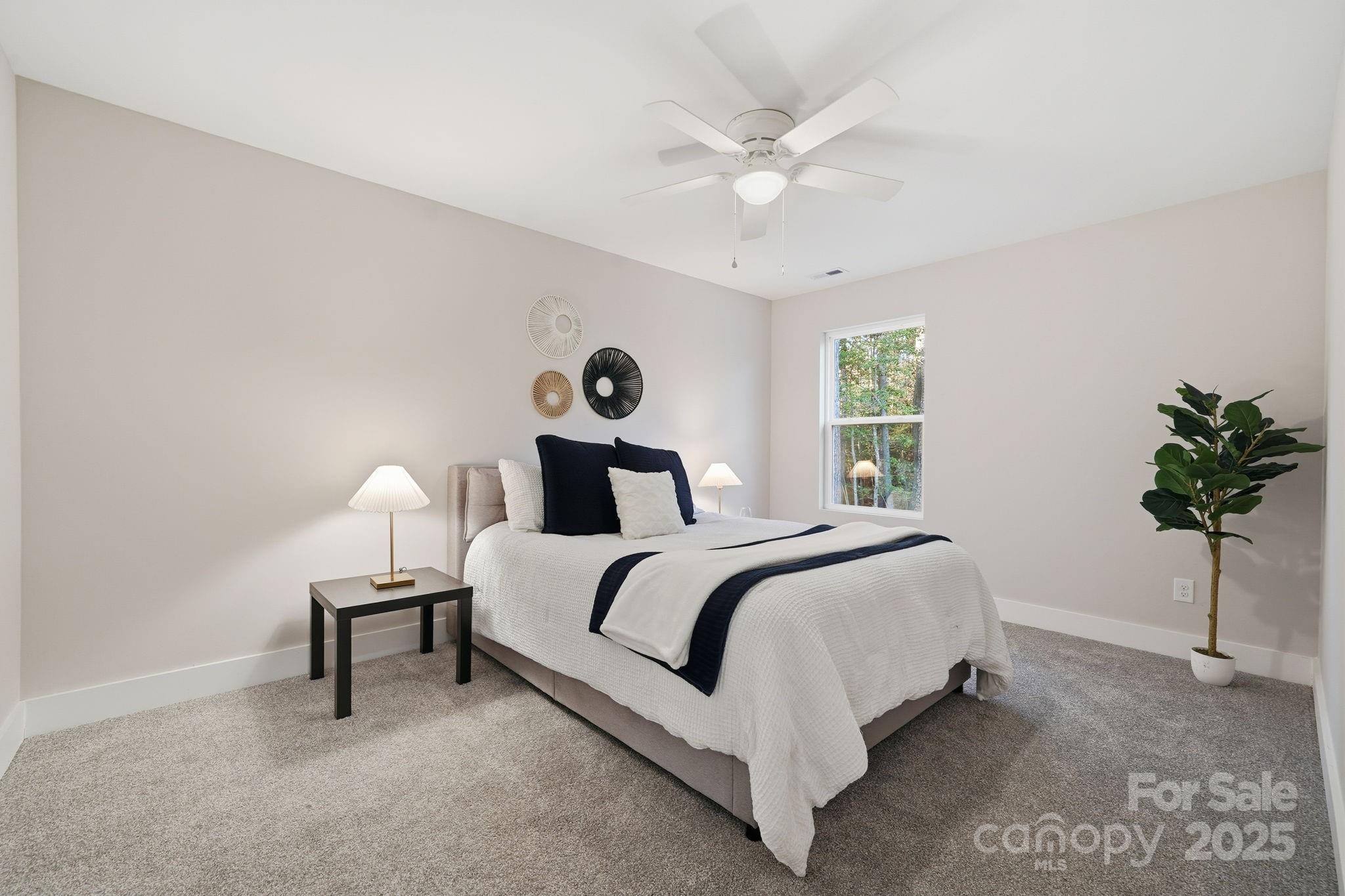 285 Mainsail Road Salisbury, NC 28146 - Photo 24 of 41 a bed room with a bed and a chandelier