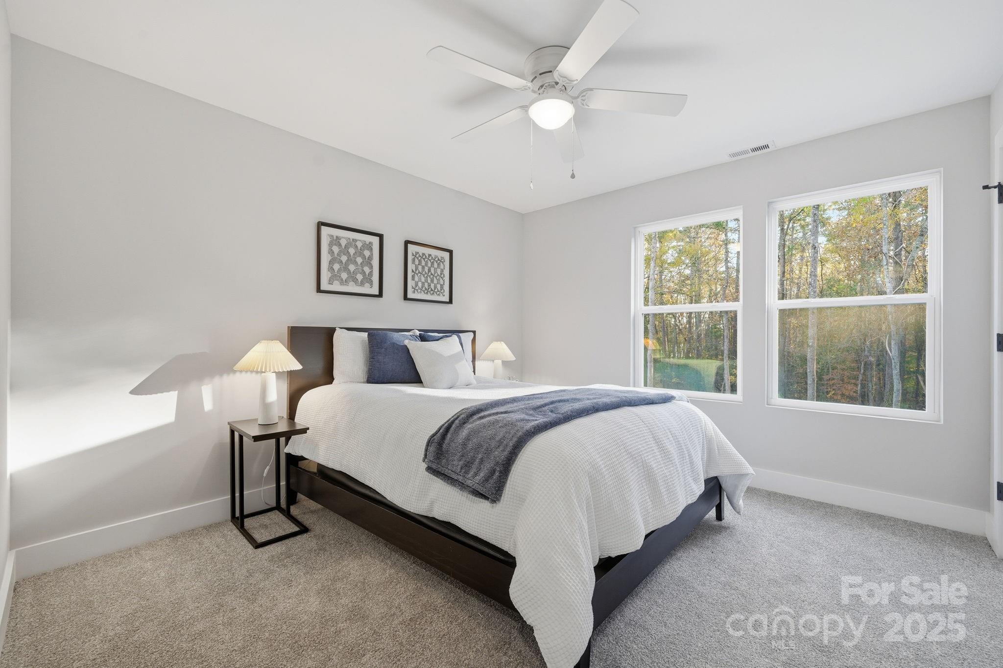 285 Mainsail Road Salisbury, NC 28146 - Photo 27 of 41 a bed sitting in a bedroom next to a window
