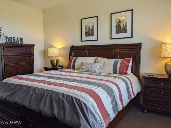 a bedroom with a bed tv and window