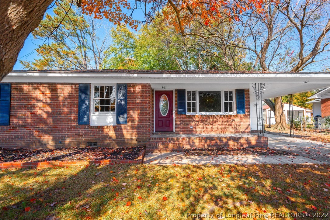 467 North Platte Road Fayetteville, NC 28303 - Photo 1 of 50 a front view of a house with a yard outdoor seating and covered with trees