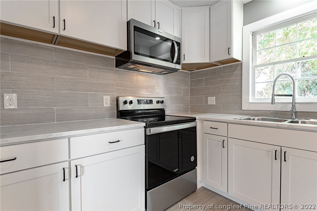 467 North Platte Road Fayetteville, NC 28303 - Photo 14 of 50 a kitchen with stainless steel appliances granite countertop white cabinets granite counter tops and a window