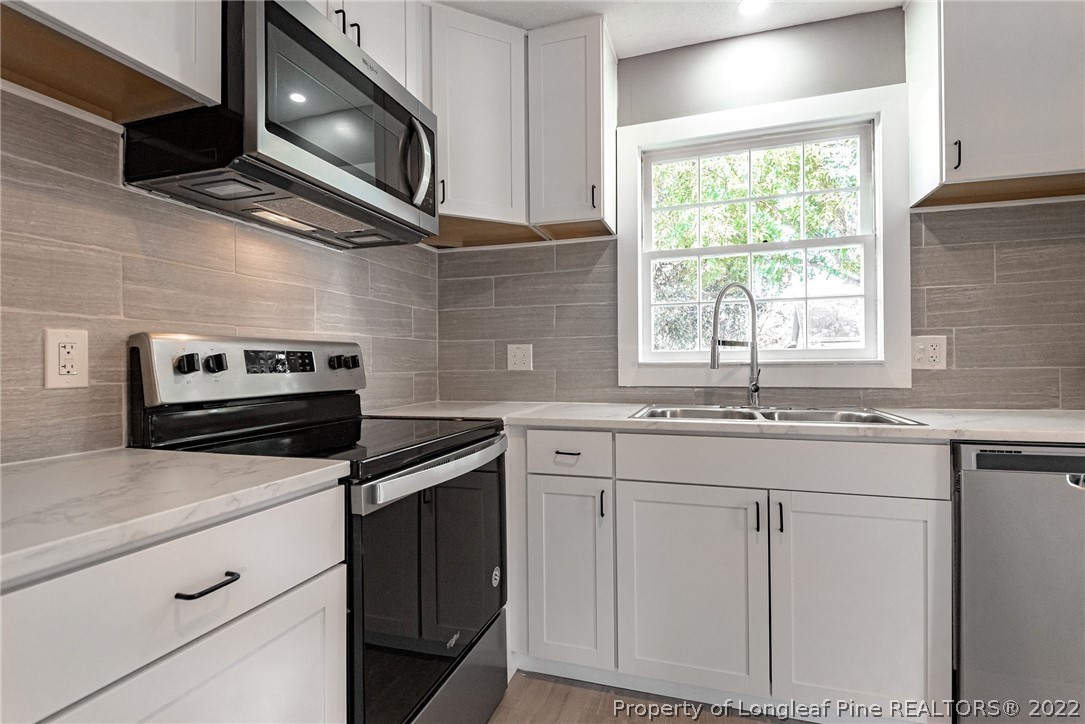 467 North Platte Road Fayetteville, NC 28303 - Photo 15 of 50 a kitchen with stainless steel appliances granite countertop cabinets a sink and a microwave