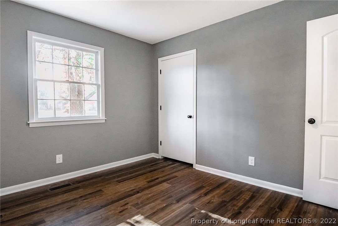 467 North Platte Road Fayetteville, NC 28303 - Photo 21 of 50 an empty room with wooden floor and windows