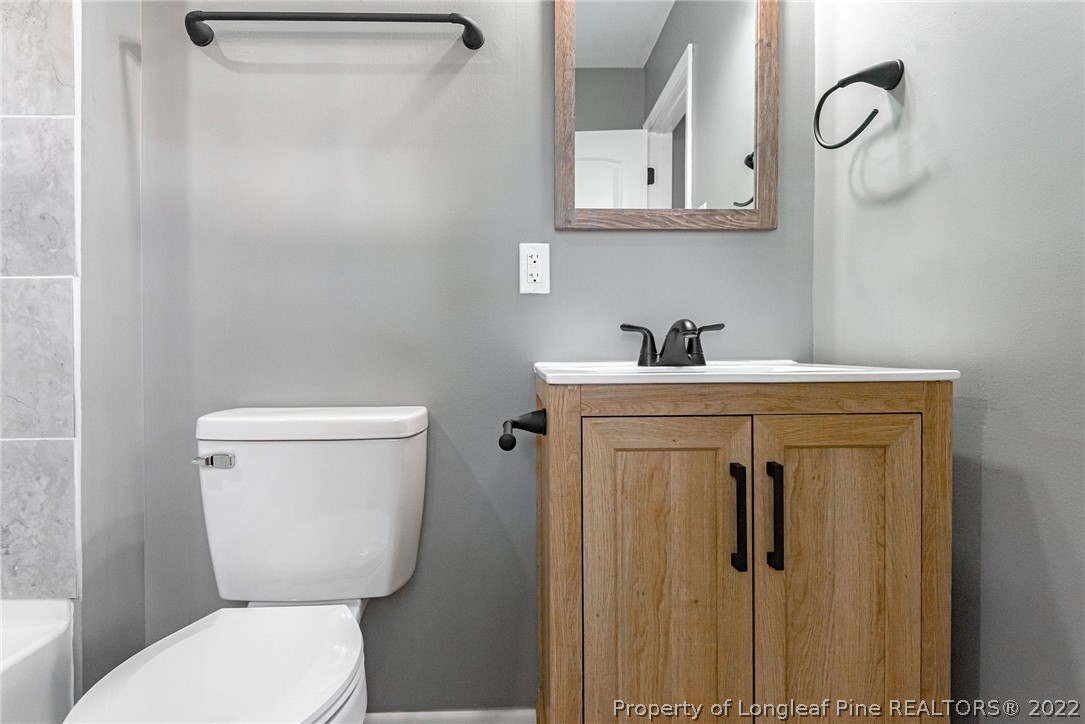 467 North Platte Road Fayetteville, NC 28303 - Photo 31 of 50 a bathroom with a toilet sink and mirror