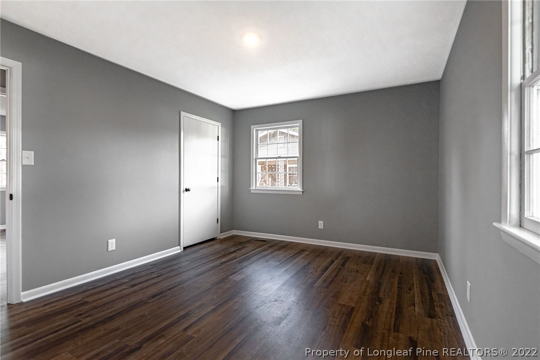 467 North Platte Road Fayetteville, NC 28303 - Photo 37 of 50 an empty room with wooden floor and windows