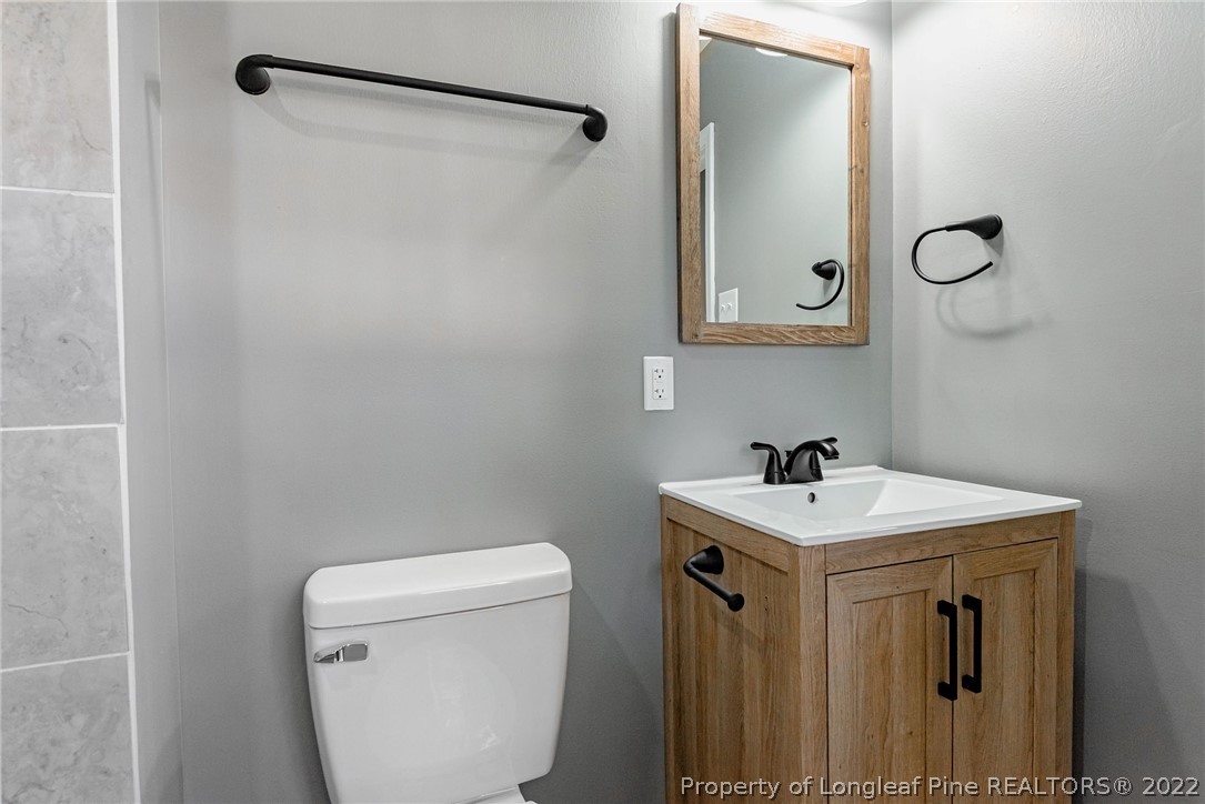 467 North Platte Road Fayetteville, NC 28303 - Photo 41 of 50 a bathroom with a sink a toilet and mirror
