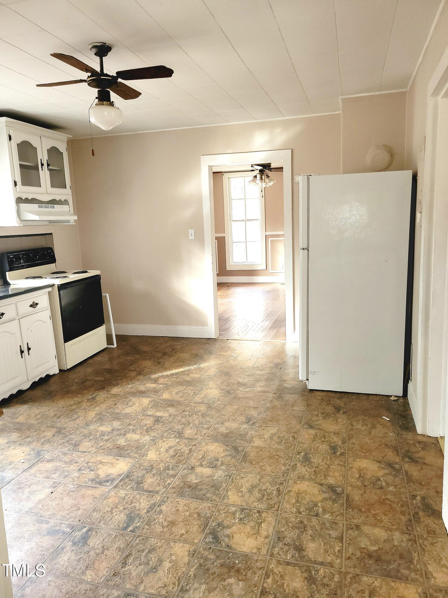 325 Ranch Farm Road, Unit A B Raleigh, NC 27603 - Photo 16 of 36 a view of a kitchen with a sink and a refrigerator