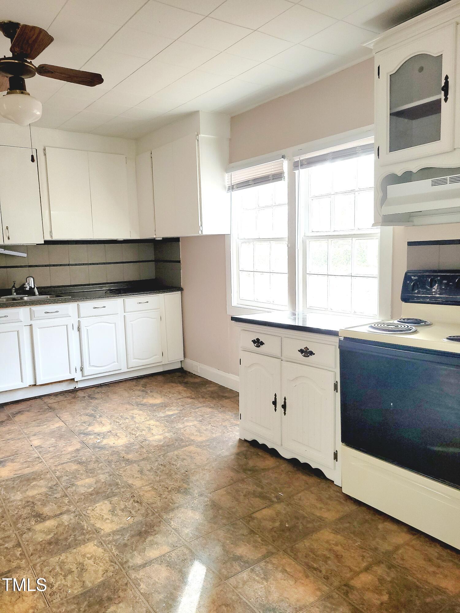 325 Ranch Farm Road, Unit A B Raleigh, NC 27603 - Photo 18 of 36 a view of a kitchen with granite countertop cabinets appliances and a window
