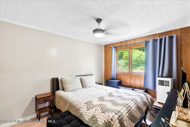 a bedroom with a large bed and a window