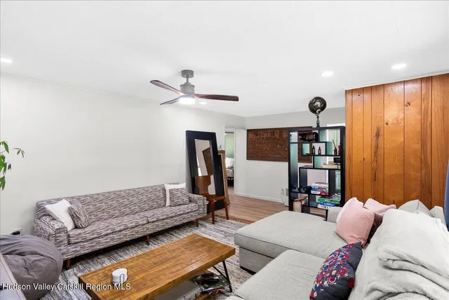 a bedroom with furniture and a book shelf