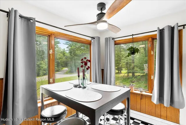 a view of a dining room with furniture large windows and wooden floor