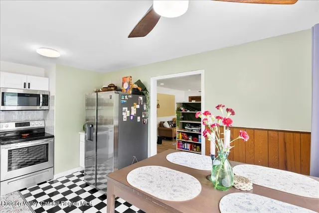 a kitchen with stainless steel appliances kitchen island granite countertop a refrigerator and a stove