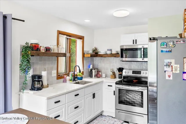 a kitchen with stainless steel appliances granite countertop a stove and a sink