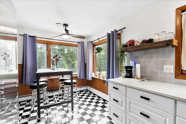 a very nice looking room with a large window and furniture