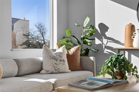 a living room with furniture flowerpot and wooden floor